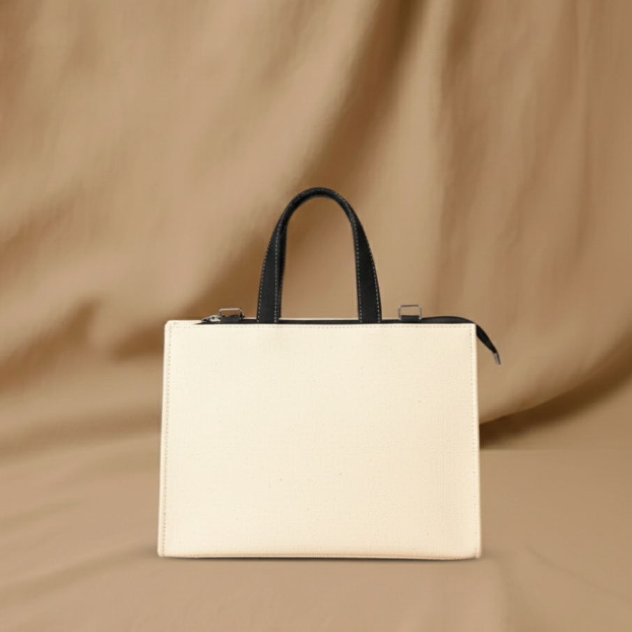 Beige handbag with black handle on a beige background