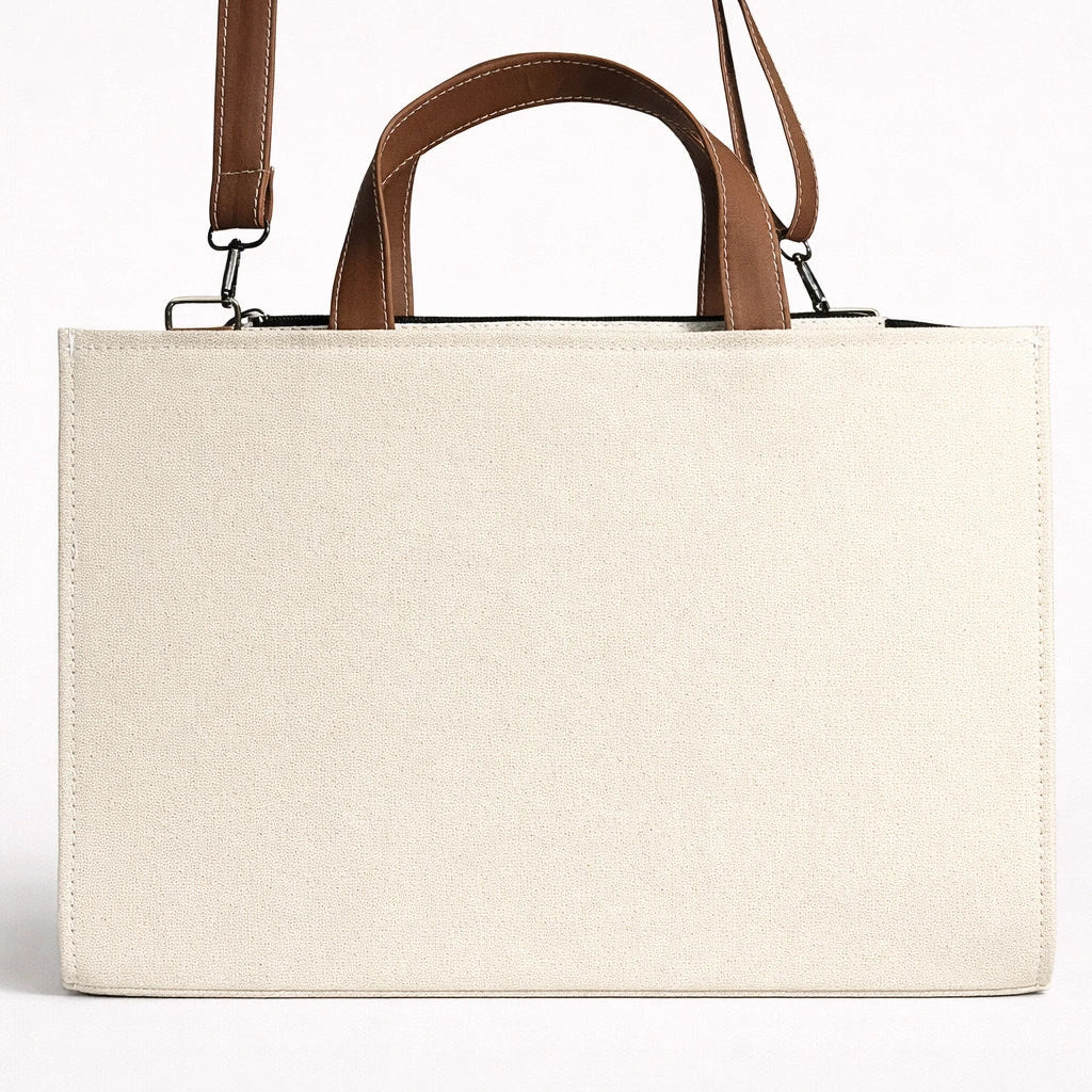Beige tote bag with brown handles on a white background