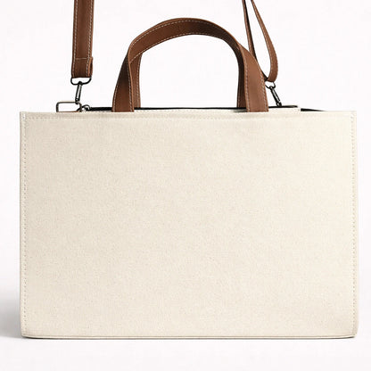 Beige tote bag with brown handles on a white background