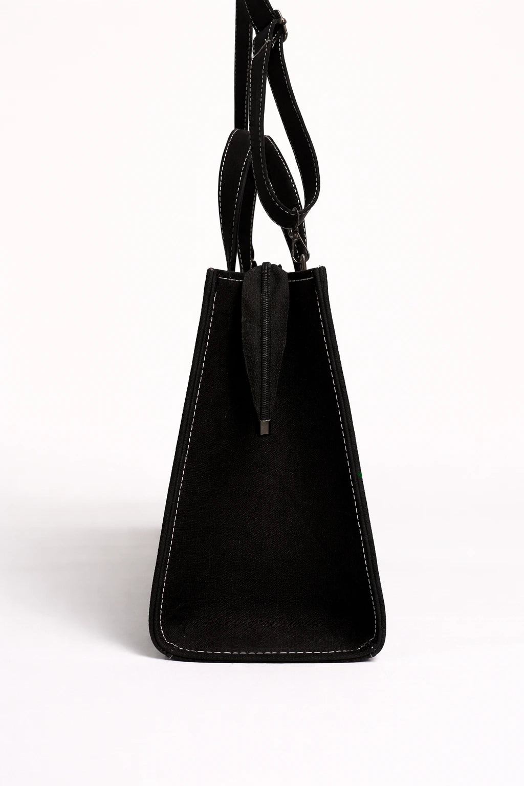 Black handbag with a strap on a white background