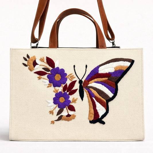 Beige handbag with butterfly and floral embroidery on a white background
