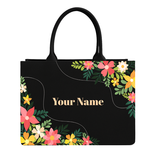 Black tote bag with floral design and 'Your Name' text on a white background