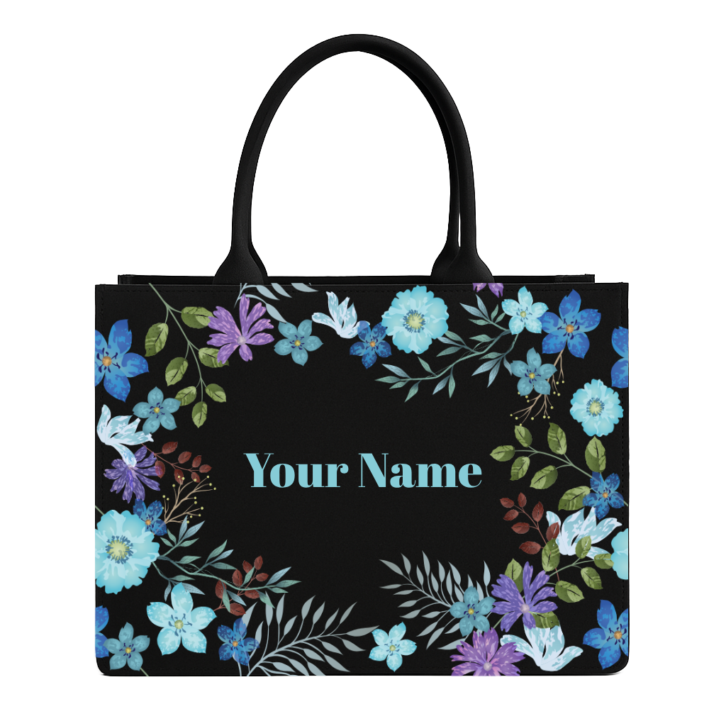 Black tote bag with floral design and space for personalization on a white background