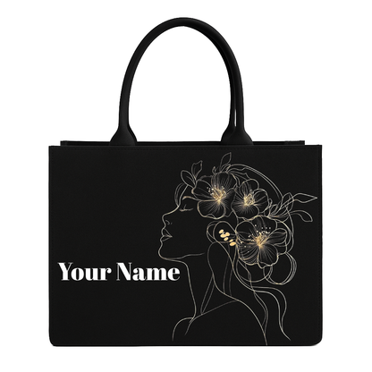 Black tote bag with floral design and 'Your Name' text on a white background