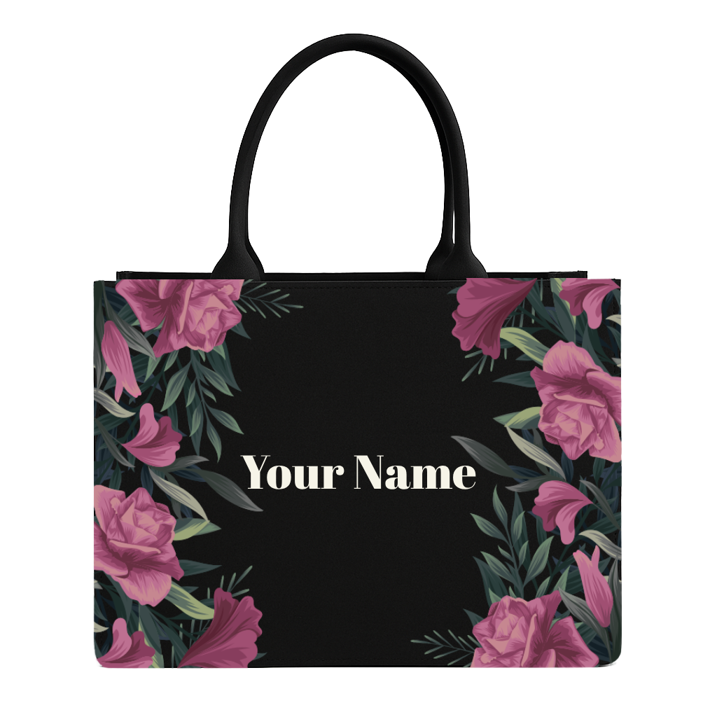 Black tote bag with pink floral design and 'Your Name' text on a white background