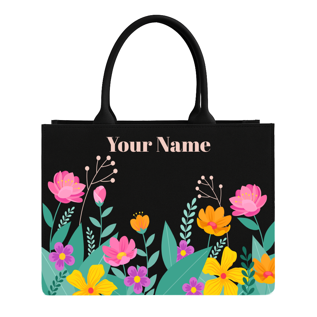 Black tote bag with colorful floral design and 'Your Name' text on a white background