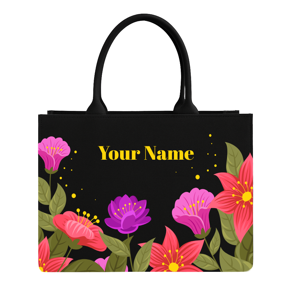 Black tote bag with colorful floral design and 'Your Name' text on a white background