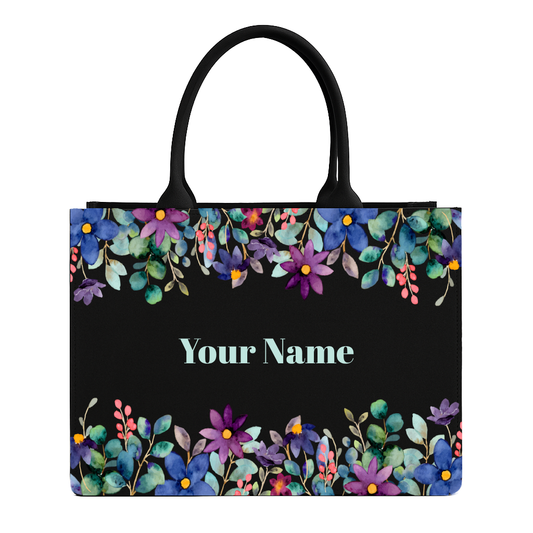 Tote bag with floral design and customizable name text on a black background
